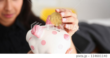 woman hold piggybank in arms put money into moneybox 114601140