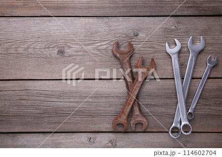 New and old wrenches for repair on grey background, copy space 114602704