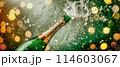 Champagne is squirting from the opening bottle , banner picture 114603067