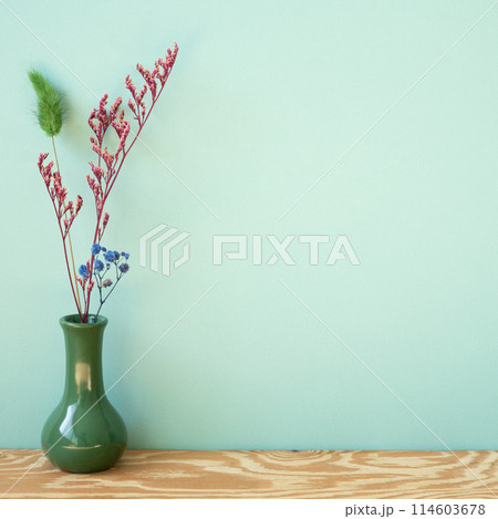 Vase of dry flower on wooden shelf. mint wall background 114603678