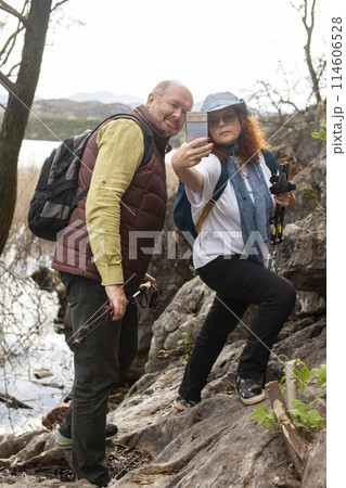 senior couple hiking outdoor, man and woman norwegian walking with sticks landscape senior couple hiking outdoor, man and woman norwegian walking with sticks landscape 114606528