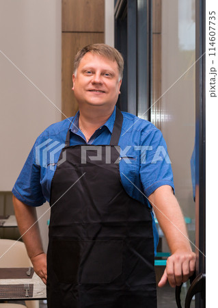 Portrait of the owner of his own cafe in a European city 114607735