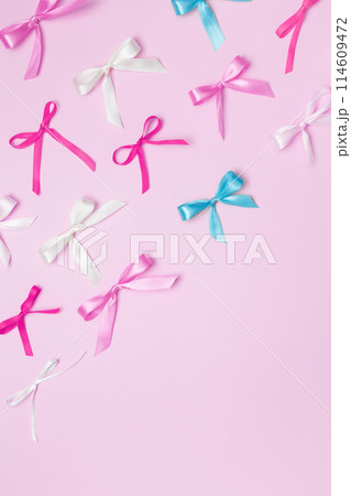 Multicolored bows on pink background. Top view, copy space 114609472