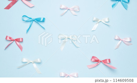 Multicolored bows on blue background. Top view Multicolored bows on blue background. Top view 114609508