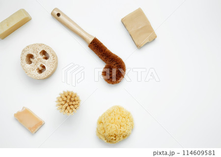 Natural organic eco cosmetics. Soap Eco, reusable cotton pads, loofah natural sponge washcloth, cotton swab, eucalyptus leaves on white background. Flat lay, top view, copy space Natural organic eco cosmetics. Soap Eco, reusable cotton pads, loofah natural sponge washcloth, cotton swab, eucalyptus leaves on white background. Flat lay, top view, copy space 114609581