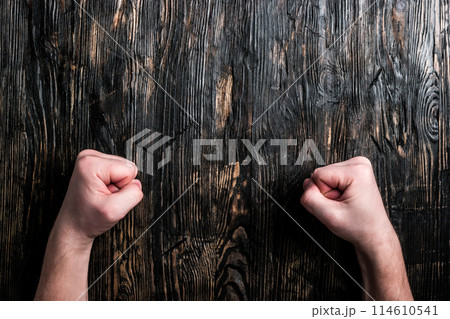 two human fists on empty table two human fists on empty table 114610541