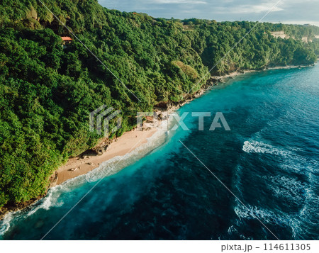 Holiday beach with turquoise tropical ocean in Bali. Drone view of Green bowl beach Holiday beach with turquoise tropical ocean in Bali. Drone view of Green bowl beach 114611305