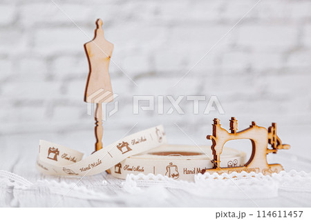 sewing tape, sewing machine and wood mannequin sewing tape, sewing machine and wood mannequin 114611457