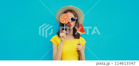 Summer portrait of stylish young woman with juicy lollipop or ice cream shaped slice of watermelon Summer portrait of stylish young woman with juicy lollipop or ice cream shaped slice of watermelon 114613547