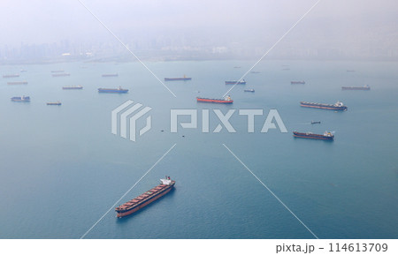 Aerial view of the Singapore Strait, Ocean liner, tanker and Cargo Ship with rainstorm in Singapore Strait, View from plane. 114613709