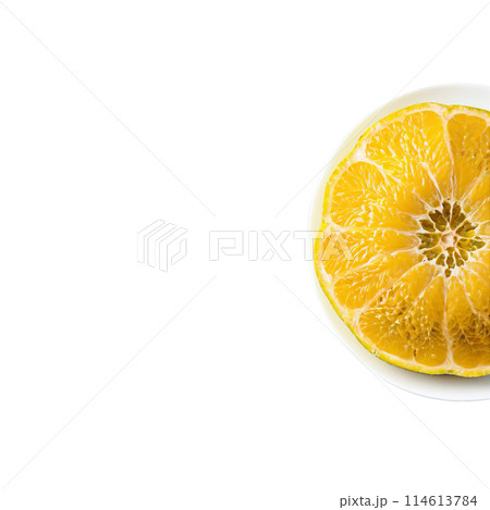 Ugli fruit large and lumpy with a mottled yellow green exterior peeled and segmented on 114613784