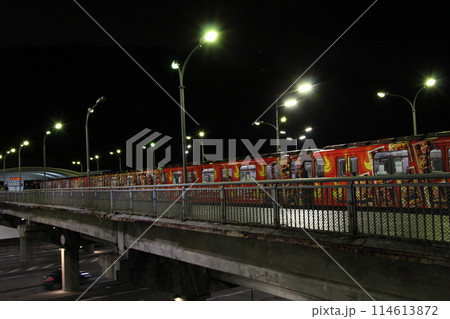 Evening electric train leaving station in subway in evening. Train leaving 114613872