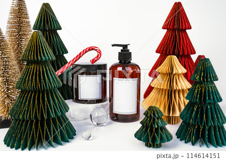 dark jar with lid and dispenser on the background of Christmas decorations, side view 114614151