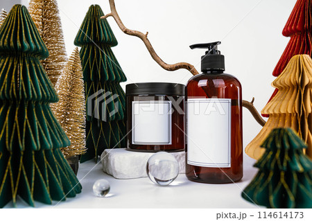 dark jar with lid and dispenser on the background of Christmas decorations, side view dark jar with lid and dispenser on the background of Christmas decorations, side view 114614173
