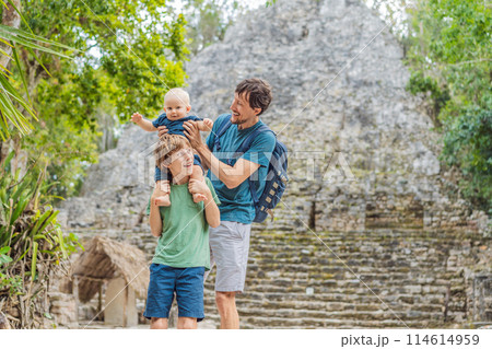 Dad with two sons tourists at Coba, Mexico. Ancient mayan city in Mexico. Coba is an archaeological area and a famous landmark of Yucatan Peninsula. Cloudy sky over a pyramid in Mexico Dad with two sons tourists at Coba, Mexico. Ancient mayan city in Mexico. Coba is an archaeological area and a famous landmark of Yucatan Peninsula. Cloudy sky over a pyramid in Mexico 114614959