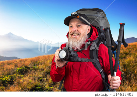 bearded man tourist photographer with a backpack photographs the beauty of nature 114615403