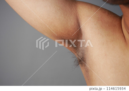 young man raised his hand up and showing his unshaven armpit young man raised his hand up and showing his unshaven armpit 114615934