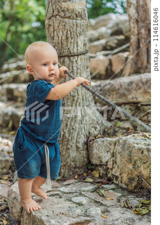 Baby tourist at Coba, Mexico. Ancient mayan city in Mexico. Coba is an archaeological area and a famous landmark of Yucatan Peninsula. Cloudy sky over a pyramid in Mexico Baby tourist at Coba, Mexico. Ancient mayan city in Mexico. Coba is an archaeological area and a famous landmark of Yucatan Peninsula. Cloudy sky over a pyramid in Mexico 114616046