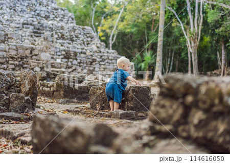 Baby tourist at Coba, Mexico. Ancient mayan city in Mexico. Coba is an archaeological area and a famous landmark of Yucatan Peninsula. Cloudy sky over a pyramid in Mexico Baby tourist at Coba, Mexico. Ancient mayan city in Mexico. Coba is an archaeological area and a famous landmark of Yucatan Peninsula. Cloudy sky over a pyramid in Mexico 114616050