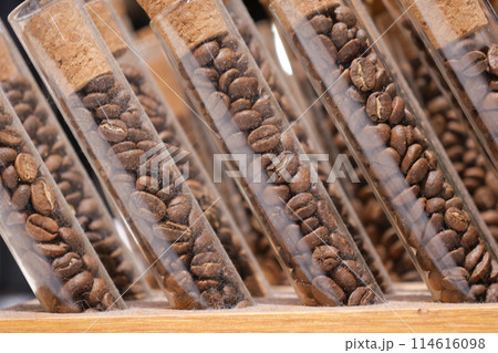 Test tubes filled with coffee beans on wooden shelf Test tubes filled with coffee beans on wooden shelf 114616098