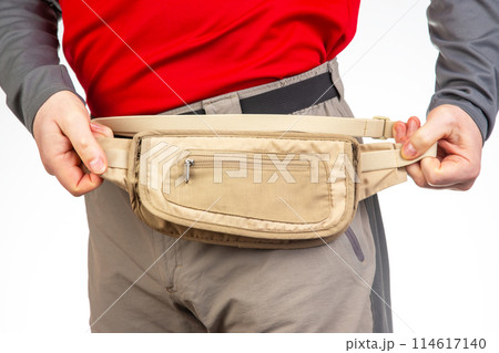 Male tourist with a waist bag for things and documents on a trip. belt bag with a zipper Male tourist with a waist bag for things and documents on a trip. belt bag with a zipper 114617140