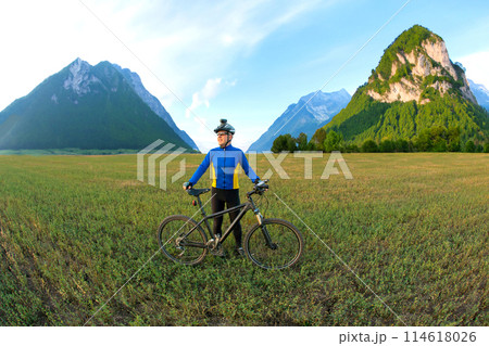 cyclist with Bicycle standing on field path cyclist with Bicycle standing on field path 114618026