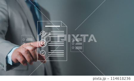 Businessman using hands to check and fill out online survey form DMS document management system, quality control and verification 114618236