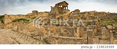 Ruins of ancient Roman capitol on territory of antic city of Dougga in area of modern Tunisia. Ruins of ancient Roman capitol on territory of antic city of Dougga in area of modern Tunisia. 114618389