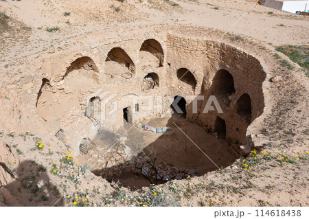 Ancient Berber dwellings carved into walls of earthen pit in Matmata Ancient Berber dwellings carved into walls of earthen pit in Matmata 114618438
