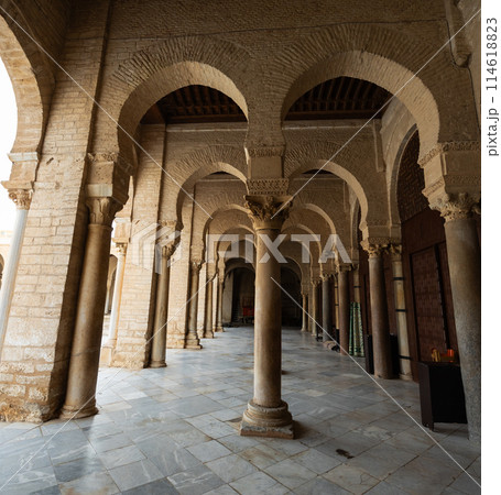 Long corridors under vaulted ceiling in ancient mosque of Kairouan in Tunisia. Long corridors under vaulted ceiling in ancient mosque of Kairouan in Tunisia. 114618823