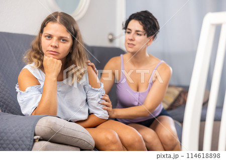 Young beautiful girl comforting her depressed girlfriend Young beautiful girl comforting her depressed girlfriend 114618898