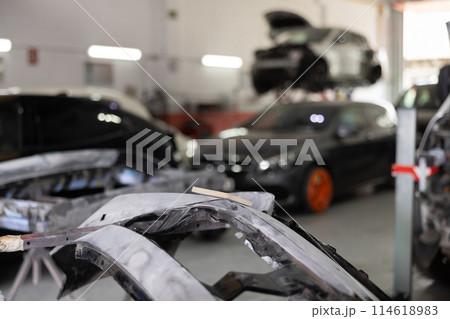 Sanded car par prepared for painting in auto repair shop 114618983