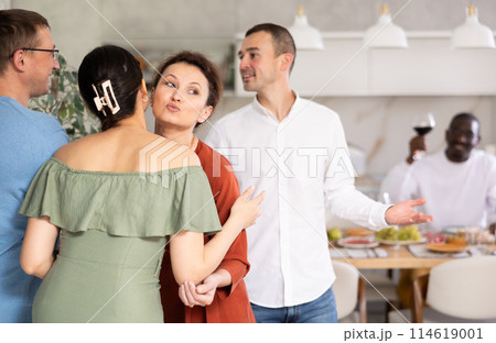 Married couples meet at home for festive dinner. Greet each other 114619001