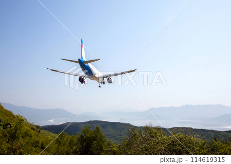 passenger plane flies over a mountain valley. air transport industry 114619315