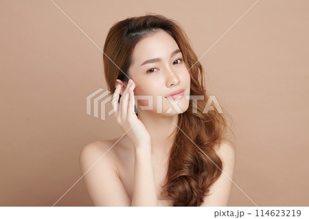 Beautiful young asian woman with clean fresh skin on beige background, Face care, Facial treatment, Cosmetology, beauty and spa, Asian women portrait. Beautiful young asian woman with clean fresh skin on beige background, Face care, Facial treatment, Cosmetology, beauty and spa, Asian women portrait. 114623219