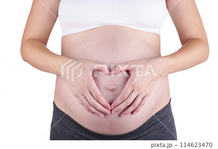 A cute pregnant belly isolated on a white background A cute pregnant belly isolated on a white background 114623470