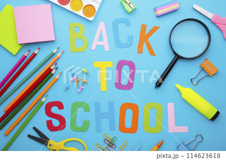 Inscription Back To School with school supplies on blue background Inscription Back To School with school supplies on blue background 114623618