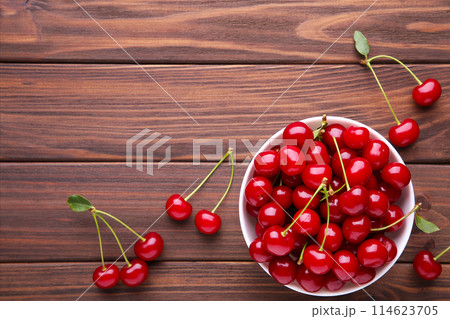 Fresh red cherry fruit on brown wooden table Fresh red cherry fruit on brown wooden table 114623705