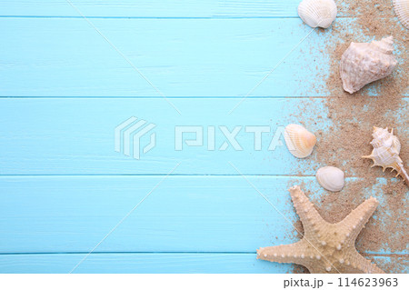 Starfish and seashells with sand on a wooden background. Summer concept Starfish and seashells with sand on a wooden background. Summer concept 114623963