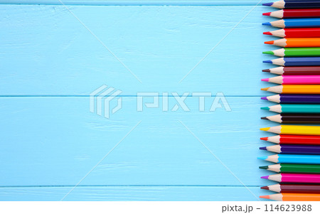 Many different colored pencils on blue wooden background Many different colored pencils on blue wooden background 114623988