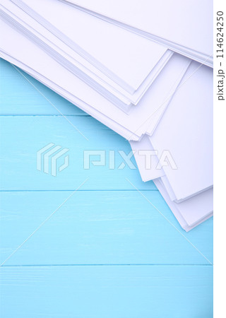 Stack white paper on blue wooden background with Clipping Path Stack white paper on blue wooden background with Clipping Path 114624250