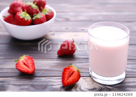 Yogurt with strawberry in glass on brown wooden background 114624269