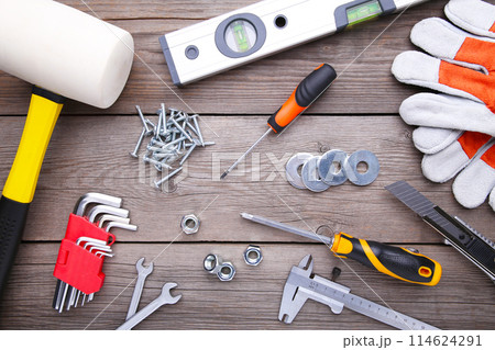 Construction tools on a grey wooden desk. Construction tools on a grey wooden desk. 114624291