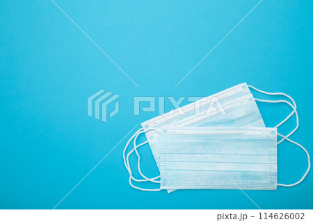 Medical masks on a blue background with copy space. Coronavirus Medical masks on a blue background with copy space. Coronavirus 114626002