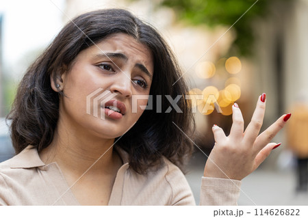 Sad unhappy frustrated Indian woman walking alone in city street feeling bad annoyed grief problem Sad unhappy frustrated Indian woman walking alone in city street feeling bad annoyed grief problem 114626822