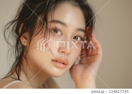 Woman with beautiful face touching healthy facial skin portrait. Beautiful happy Asian girl model with natural 114627145