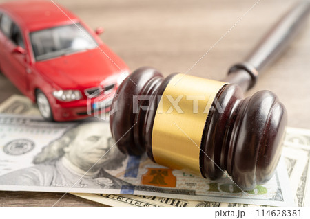 Hammer gavel judge and US dollar banknote money with car vehicle accident, insurance coverage claim lawsuit court case. 114628381
