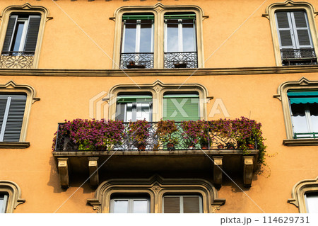 vibrant flower balcony on a traditional european building vibrant flower balcony on a traditional european building 114629731