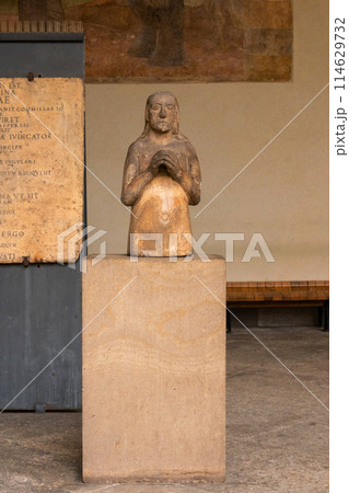 stone sculpture of kneeling figure in milan stone sculpture of kneeling figure in milan 114629732