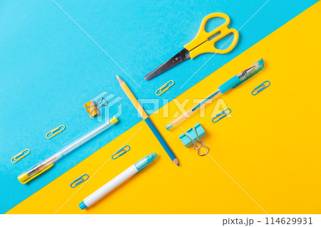 Blue and yellow office supplies on background. Flat lay. Back to school. Education and bussines concept 114629931